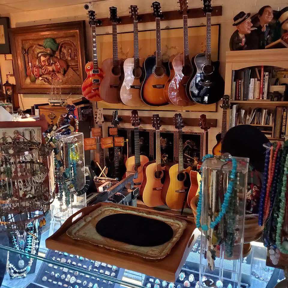 Guitars on the wall above jewelry displays