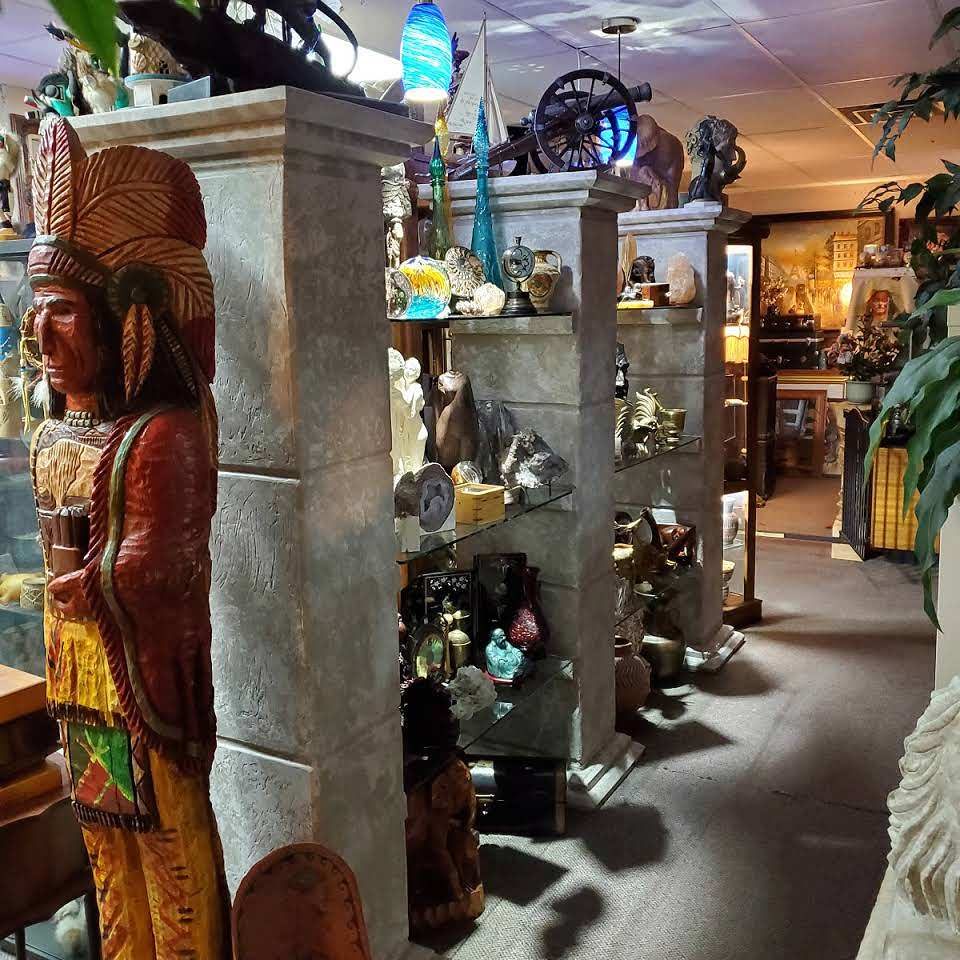 The showroom: carved wooden figures, glass art and antiques on display